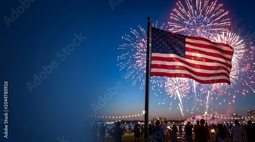 American flag waving on a flagpole at night with spectacular colorful fireworks exploding in the sky during 4th of July Independence Day celebration with a crowd of people watching