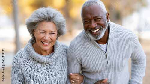 Cheerful Senior Couple Walking Together Outdoors in Sunny Park, Healthy Active Lifestyle, Retirement Planning and Healthcare Marketing Image

