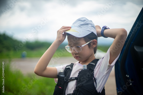 Young hiker adjusting his cap before outdoor trail activity