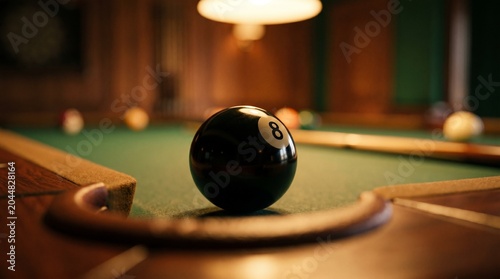 Photos Close-up of an eight ball on a pool table in a dimly lit room