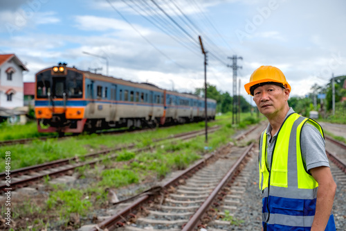 Photos Japanese train engineer man standing at rail tracks with locomotive train backgr