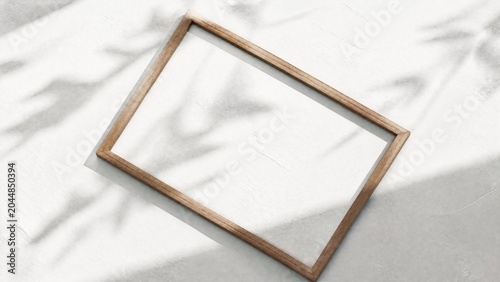 Slim wooden frame on a textured white surface, showcasing natural shadows and minimalist design.