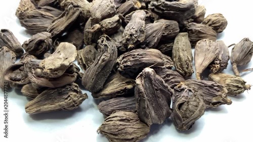 Pile of Dried Black Cardamom Pods, Whole black cardamom (Amomum subulatum) seed pods, an aromatic Indian spice.herbal medicine, traditional Indian seasoning, and healthy food photography.
