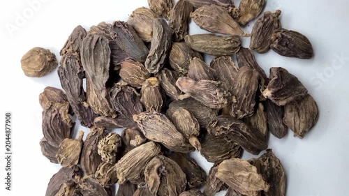 Pile of Dried Black Cardamom Pods, Whole black cardamom (Amomum subulatum) seed pods, an aromatic Indian spice.herbal medicine, traditional Indian seasoning, and healthy food photography.