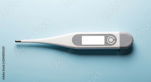 Digital thermometer on blue background, medical temperature measurement tool