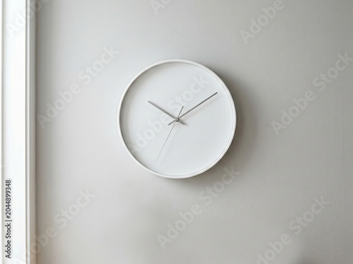Minimalist Wall Clock: A clean, modern white wall clock with simple hands tells time against a muted grey background, embodying a sense of calm and order.