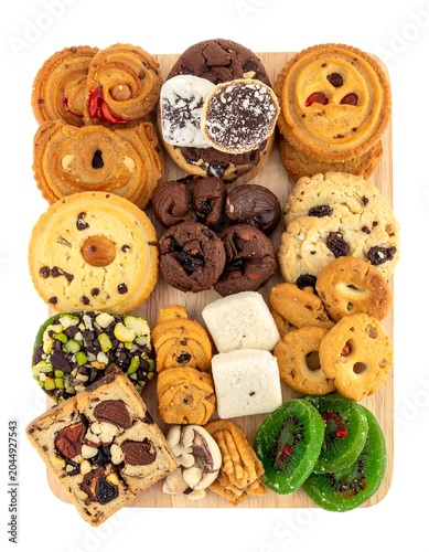 A square wooden board filled with an assortment of sweet baked goods