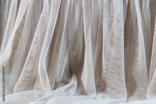 Cream beige mesh fabric with a fine net texture and soft folds