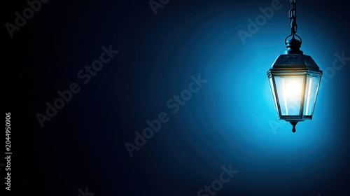 Vintage lantern glowing with warm light in dark blue background