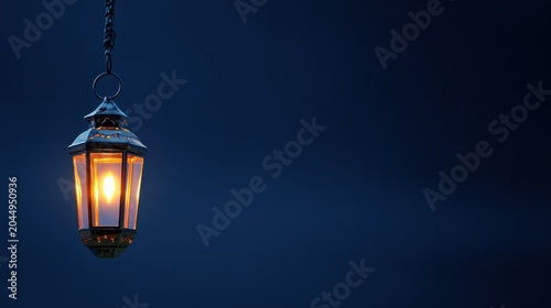 Hanging ancient lantern glowing warm light in darkness