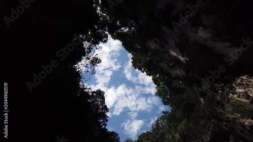 Majestic Limestone Cave Interior With Sunlight and Greenery