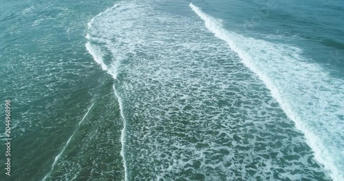 Drone shot of calm sea surface with white foam lines The Concept of peaceful nature