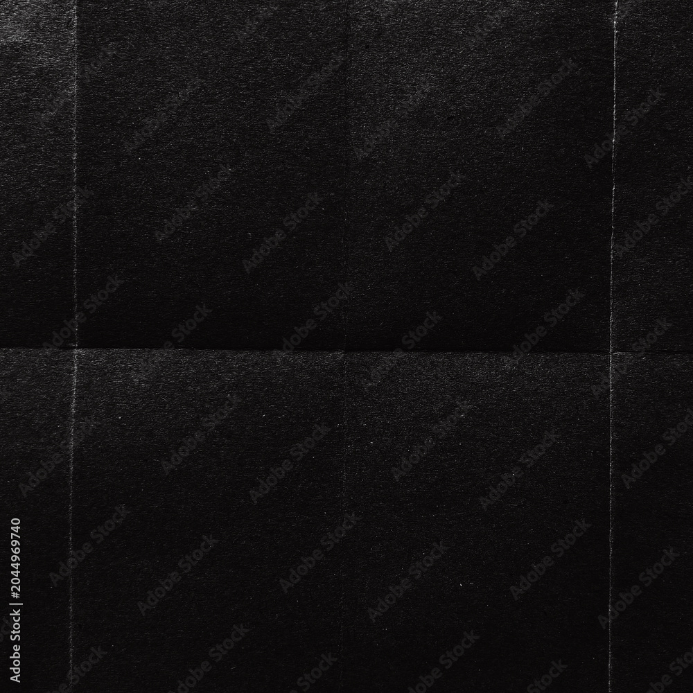 Fototapeta premium A textured black surface with subtle grid lines creating a pattern.