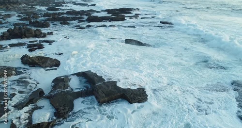 Heavy ocean waves crashing against dark rocks The Concept of natural force