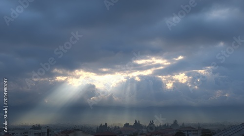 The sunlight shines through the clouds, it's so beautiful. in the morning
