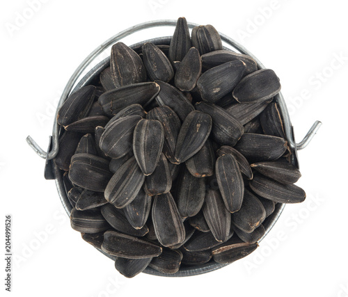 Sunflower seeds in a bucket isolated on white background.