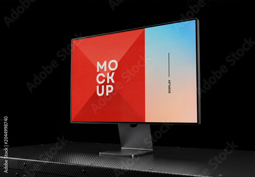 Perspective view of a desktop computer monitor screen mockup standing on a carbon fiber textured surface table against a solid black background