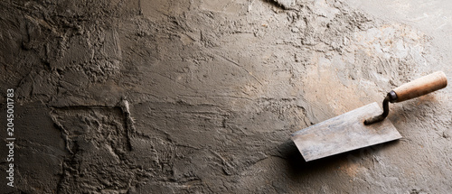 Masonry Trowel on Rough Concrete Wall Texture