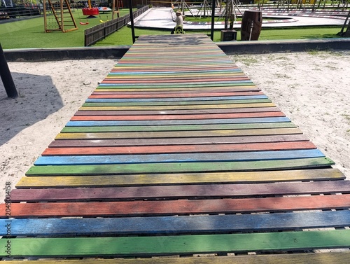 Rainbow Painted Wooden Bridge in Outdoor Playground