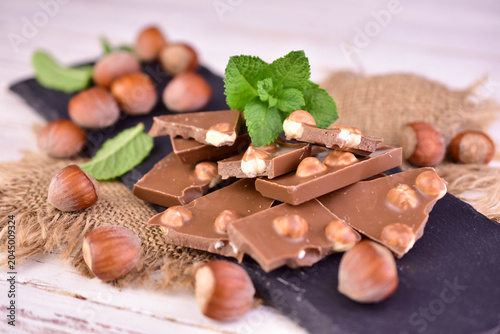 фотографія Milk chocolate with hazelnuts. Close-up.