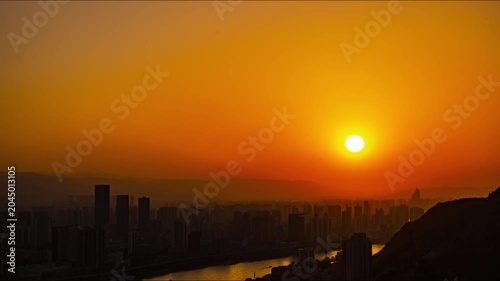 Golden sunset over city skyline and river