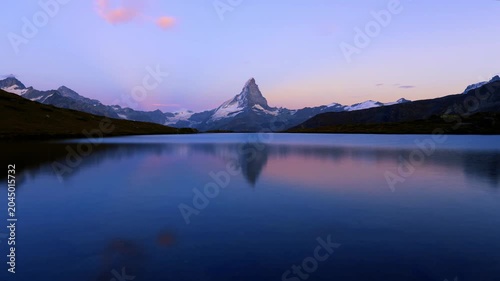 Matterhorn reflected in calm alpine lake at dusk near Zermatt, Switzerland