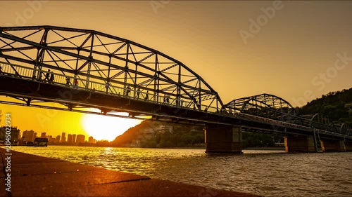 Silhouette Steel Truss Bridge Over River at Sunset
