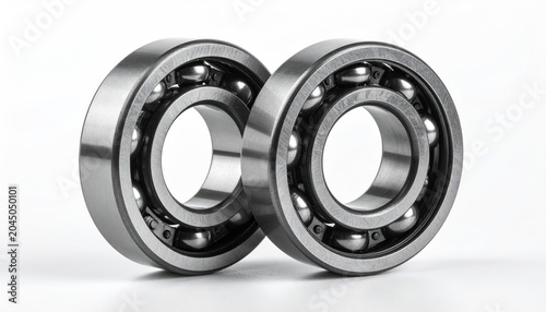 Two shiny metal ball bearings against a plain white backdrop