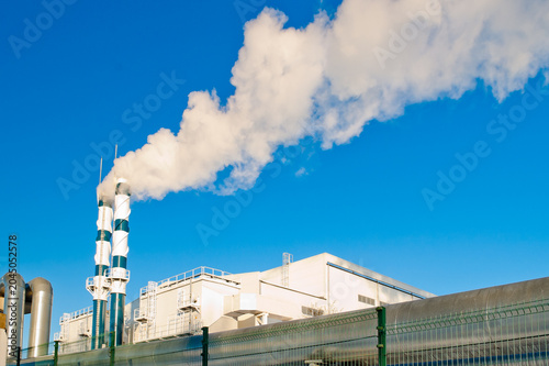 Εκτύπωση καμβά A heating plant and pipes emitting white smoke, with a pipeline in the foregroun