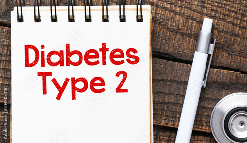 DIABETES TYPE 2 words in the notebook next to the stethoscope.