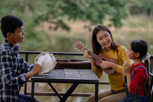 Фотография The family is playing music and singing together in the garden.