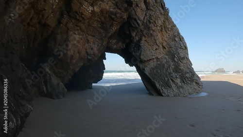Static Wide Shot of Sea Arch Rock Formation at Praia da Adraga, Sintra, Portugal