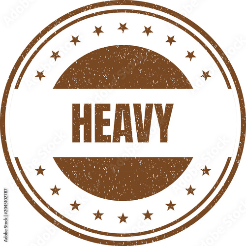 Fotografija Circular vintage stamp with the word heavy printed in a bold brown font and star