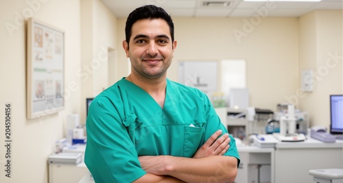 Portrait of confident male doctor with arms crossed standing at clinic.doctor in a medical dressing gown
