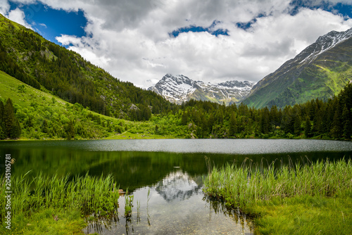 Snowy peak reflected in a calm mountain lake