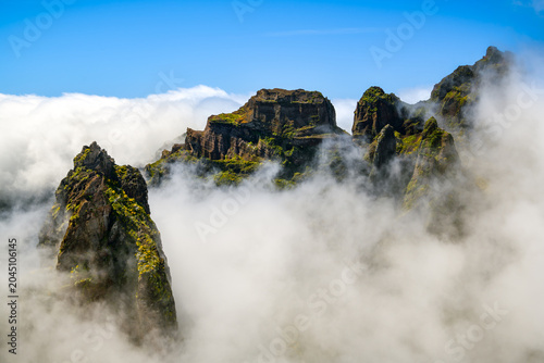Volcanic peaks rising above a sea of clouds