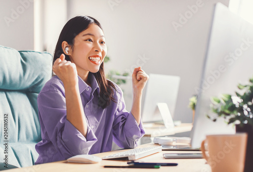 Fotografía Happy Young Asian Woman Smiling At Computer Screen With Excitement, Celebrating