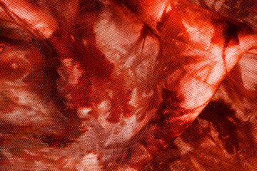 Macro view of red tie dye fabric texture