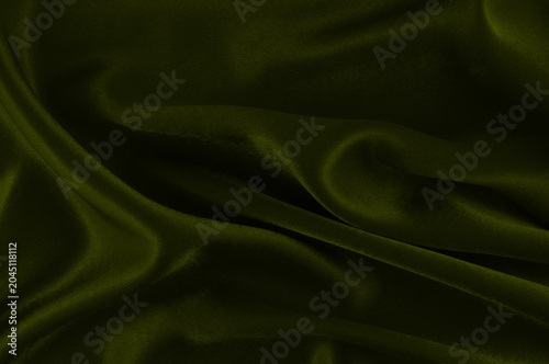 фотографія Olive green velvet fabric draped texture background