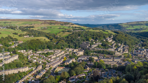 High aerial view of the town of Hebden Bridge in West Yorkshire showing the streets surrounded by autumn countryside