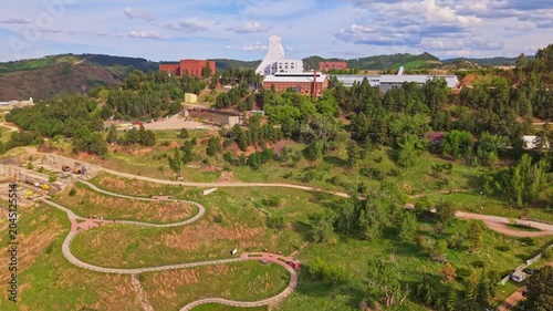 Scenic aerial view of Lead South Dakota surrounded by forested hills on a summer day