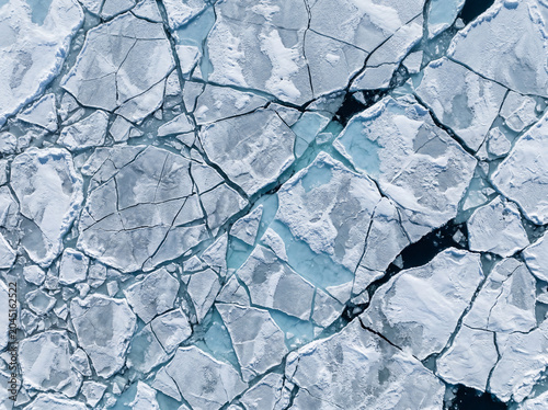 Fractured Arctic Ice Sheet Aerial Texture — Blue and White Geometric Pattern