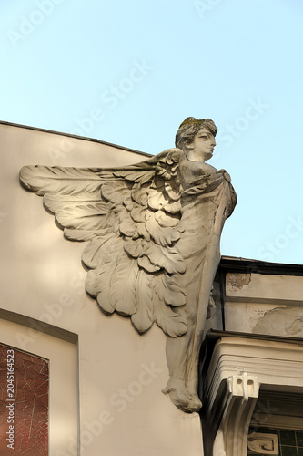 Close-up architectural detail of a winged stone sculpture adorning the facade of an old building, Kyiv. Ukraine