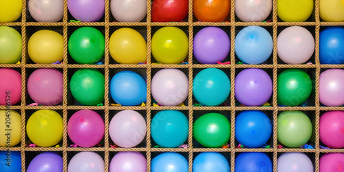 фотографія colorful banner background with intact balloons arranged in carnival game display