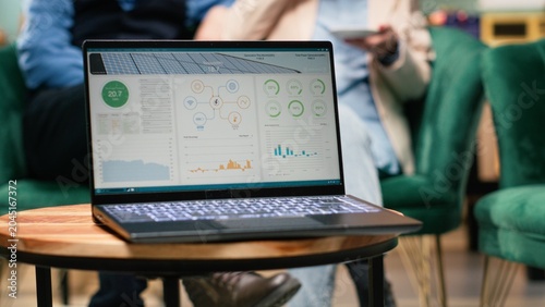 Photography Photovoltaic panels system software running on laptop screen, aged couple believing in renewable energy and sustainable clean power, Green technology in energy-efficient household, eco-friendly