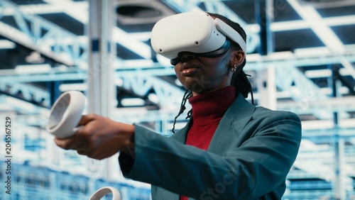 Tableau sur toile Data center smiling programmer uses VR headset technology to visualize equipment powering internet services, Happy server farm expert uses virtual reality simulation to oversee systems, camera B