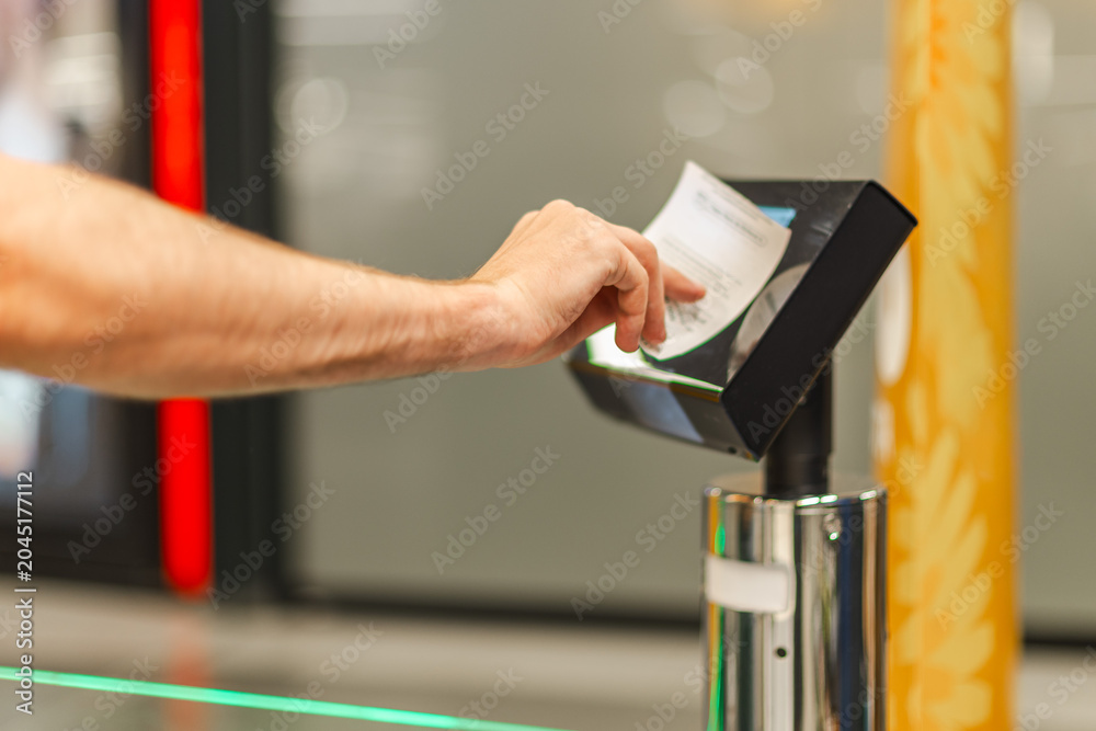 Obraz premium Man scanning paper receipt at self checkout terminal, using automated retail system for purchase verification and secure supermarket transaction