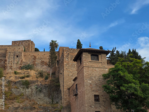 Alcazaba of Malaga Fortress Walls and Tower under Blue Sky in Andalusia Spain