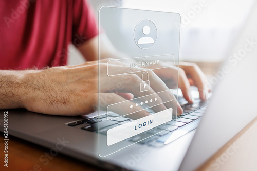 Valokuva Person logging into a digital account on laptop, entering username and password