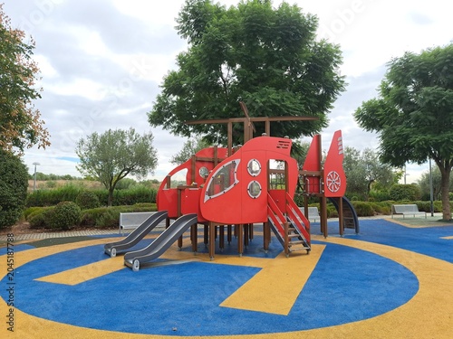 Empty colorful playground on rubber ground in the park

